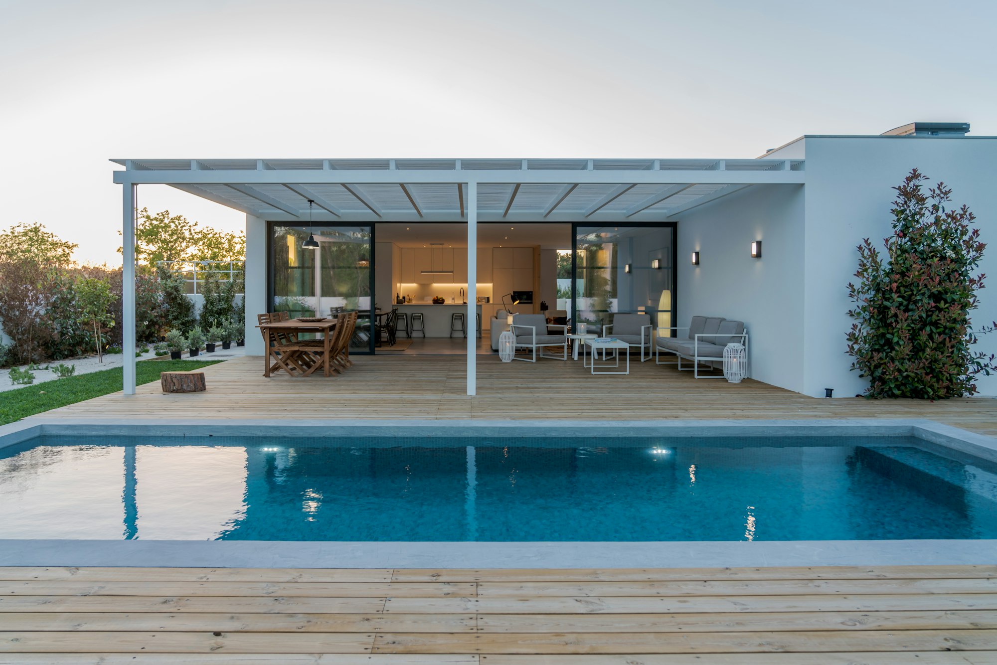 Modern house with garden swimming pool and wooden deck
